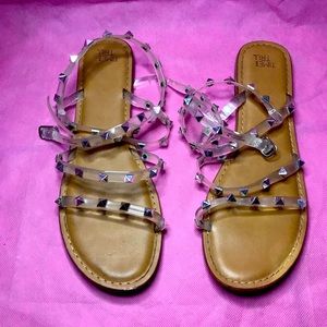 Brown Sandals with clear straps and silver spikes.